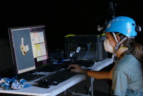 An Autonomous Assistant for Multi-Robot Operations in Cave Exploration